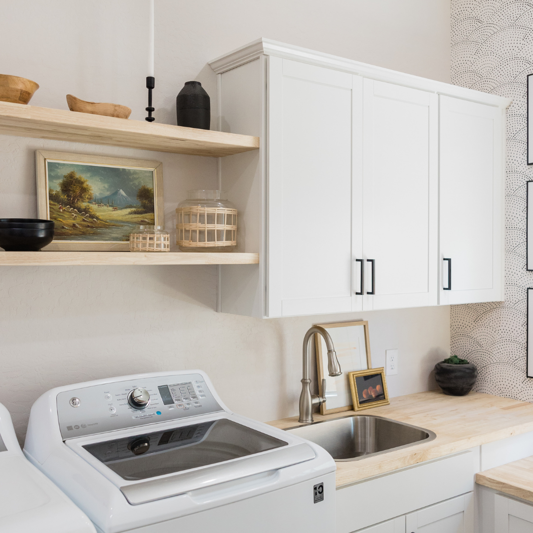 A laundry room with a washer and dryer and a sink