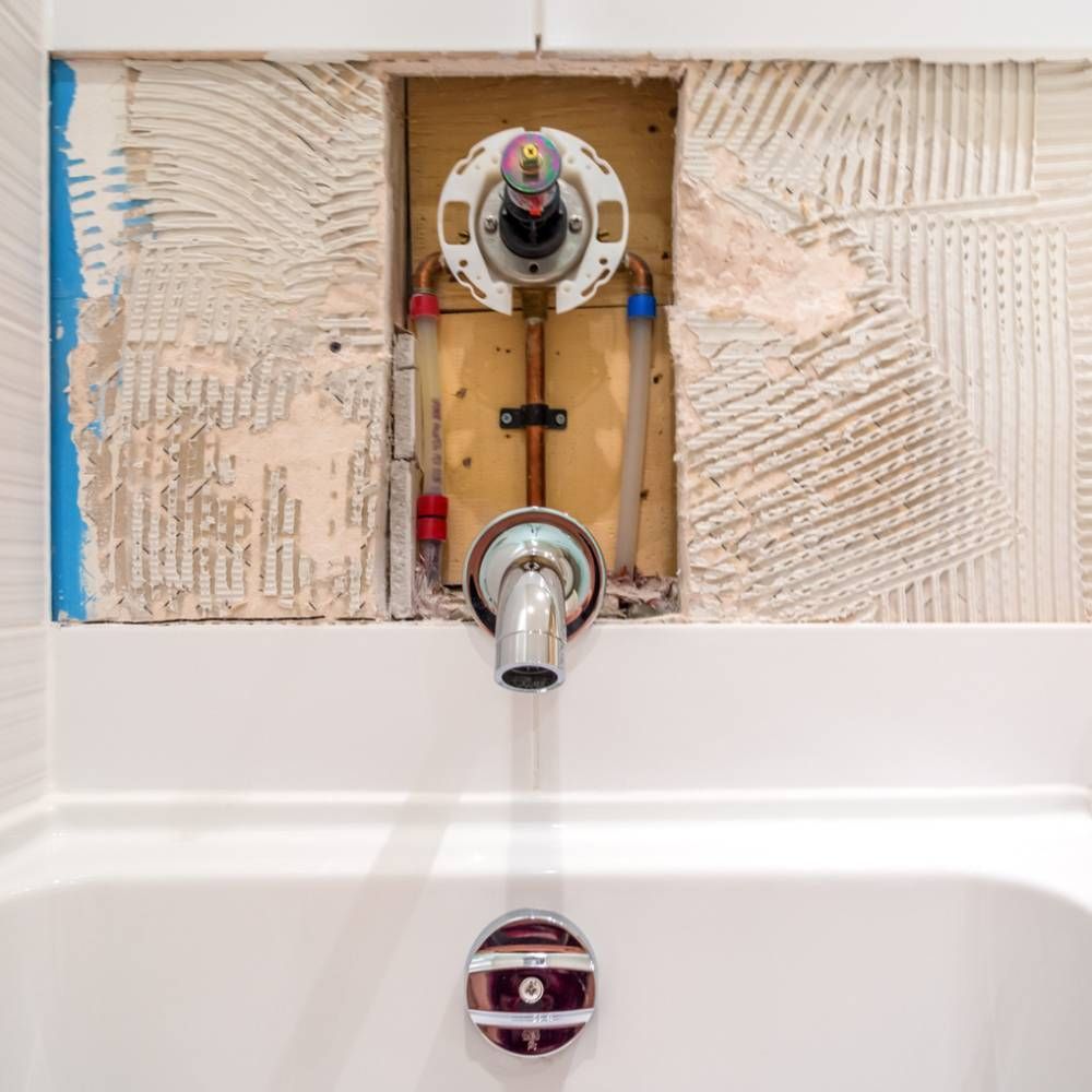 A laundry room with a washer and dryer and a sink