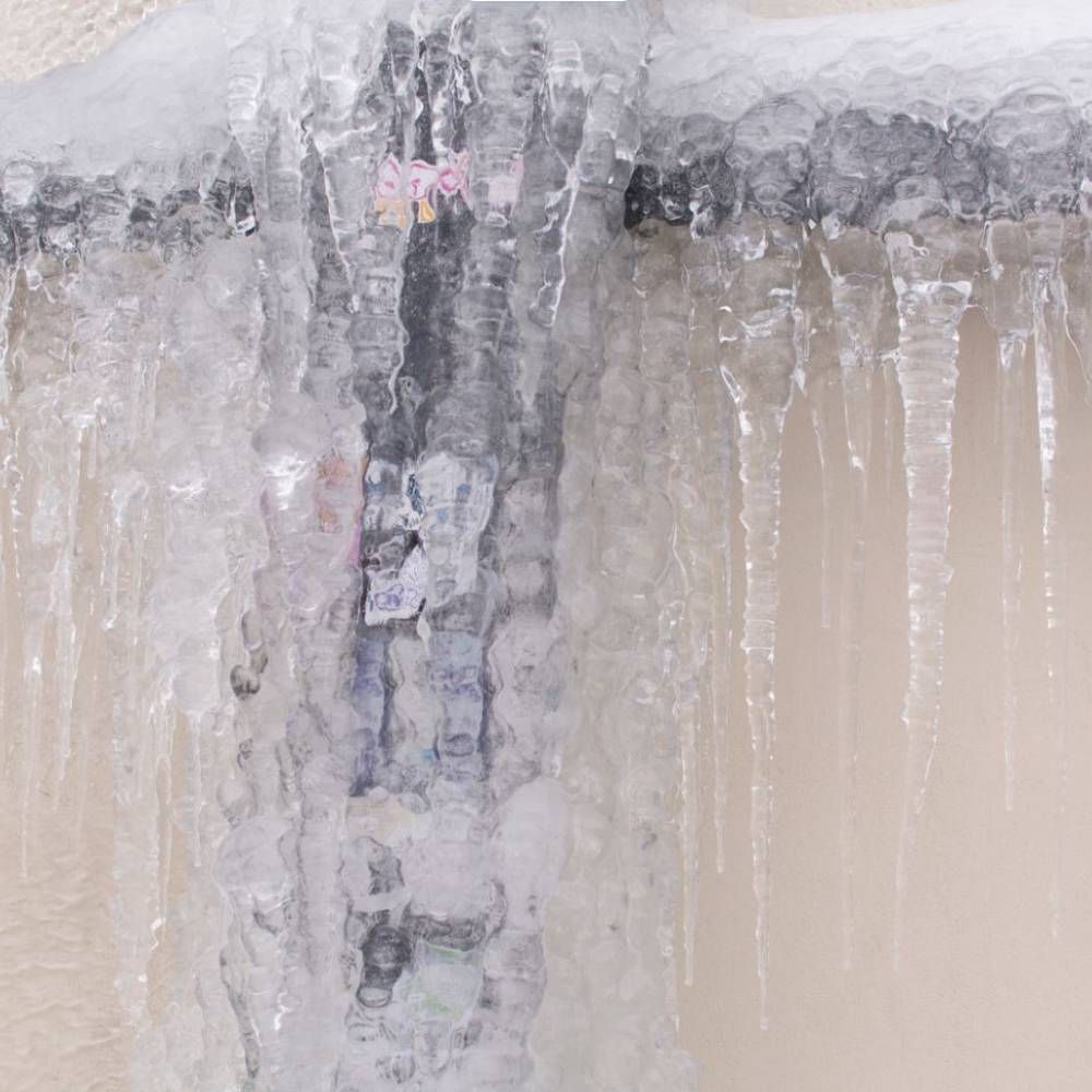 A close up of a faucet with ice on it