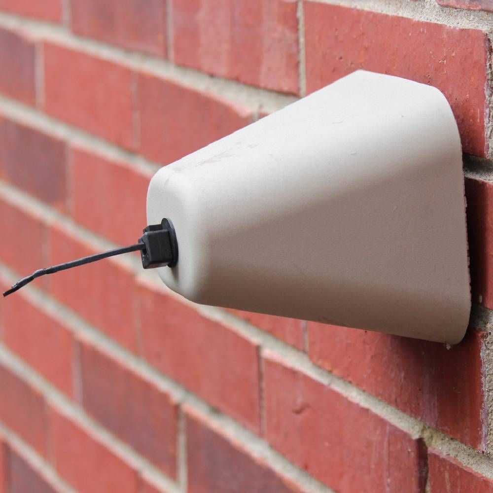 A white buoy is attached to a wooden wall.