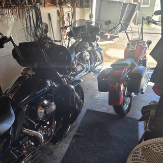 Two harley davidson motorcycles are parked in a garage