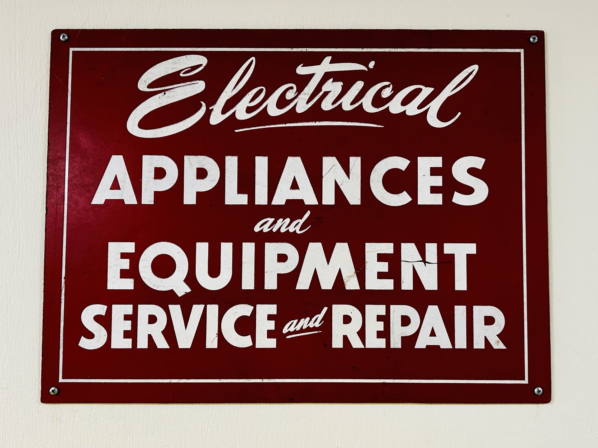 A red sign that says electrical appliances and equipment service and repair
