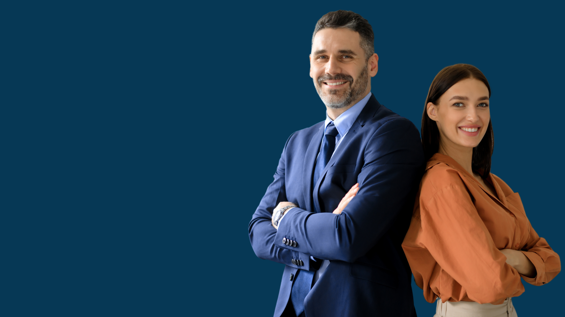 A man and a woman are standing back to back with their arms crossed.