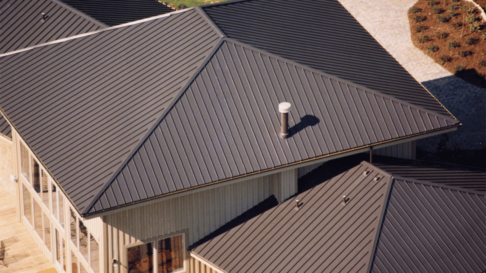 An aerial view of a house with a black roof