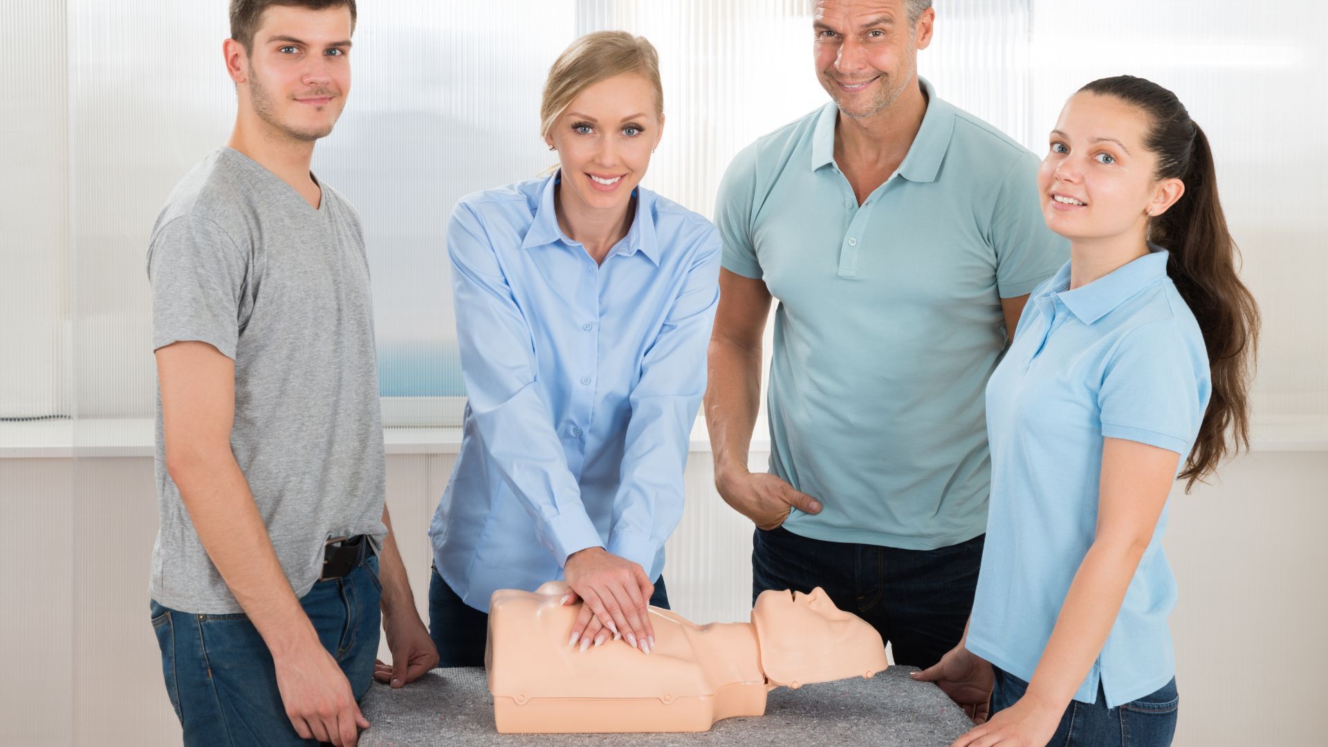 A group of people are standing around a mannequin.