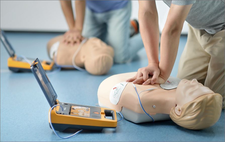 A man is doing a heart massage on a mannequin.