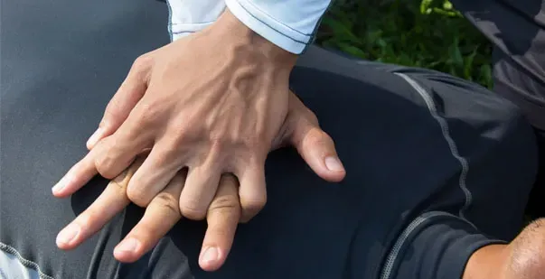 A close up of a person 's hands on another person 's back.