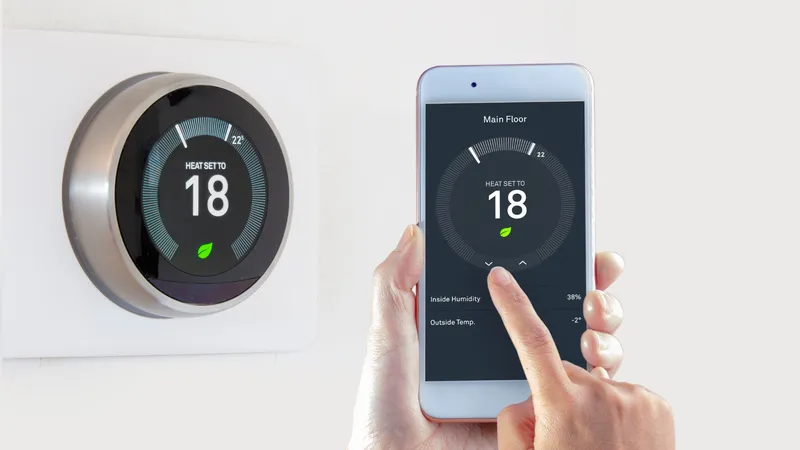 Smart thermostat and smartphone app both showing 18° on a white wall.