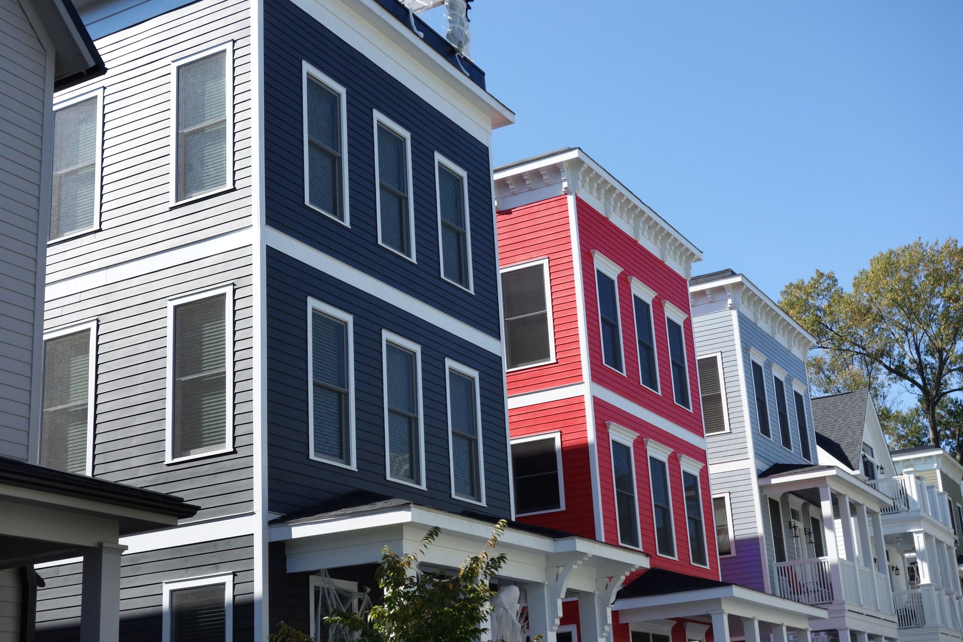 A row of colorful houses with a blue sky in the background