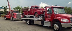 Towing a Red Mini Truck — Dearborn, MI — Rusko’s Service Center