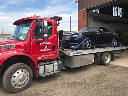Black Car on a Tow Truck — Dearborn, MI — Rusko’s Service Center