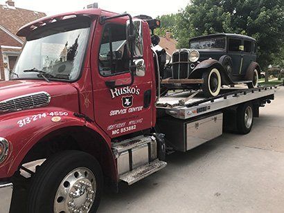 Black Vintage Car on a Tow Truck — Dearborn, MI — Rusko’s Service Center