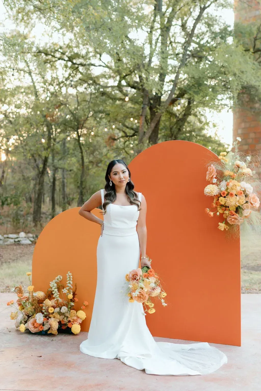 The bride is wearing a white dress and holding a bouquet of flowers.