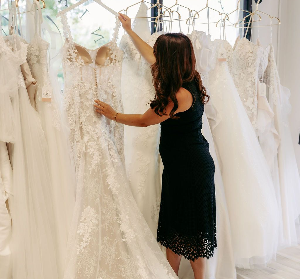 A woman is trying on a wedding dress in a bridal shop.