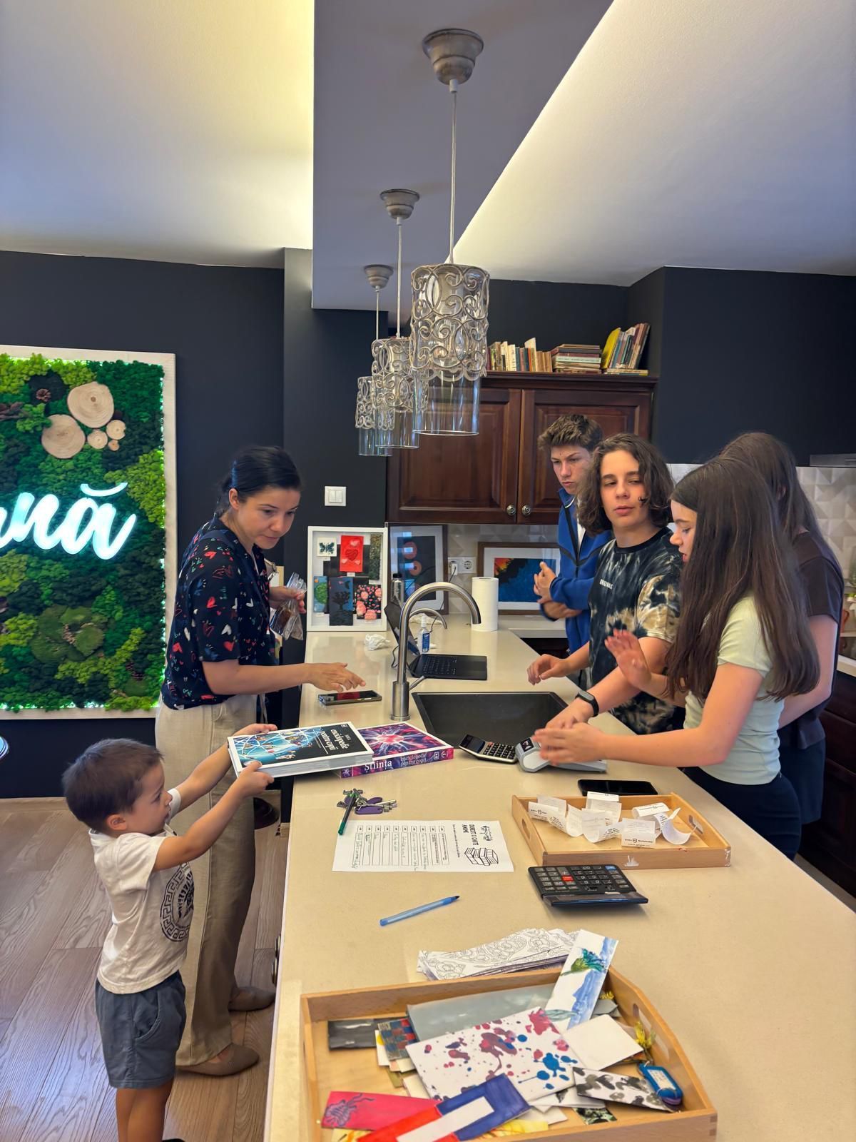 A group of people are standing around a kitchen counter.