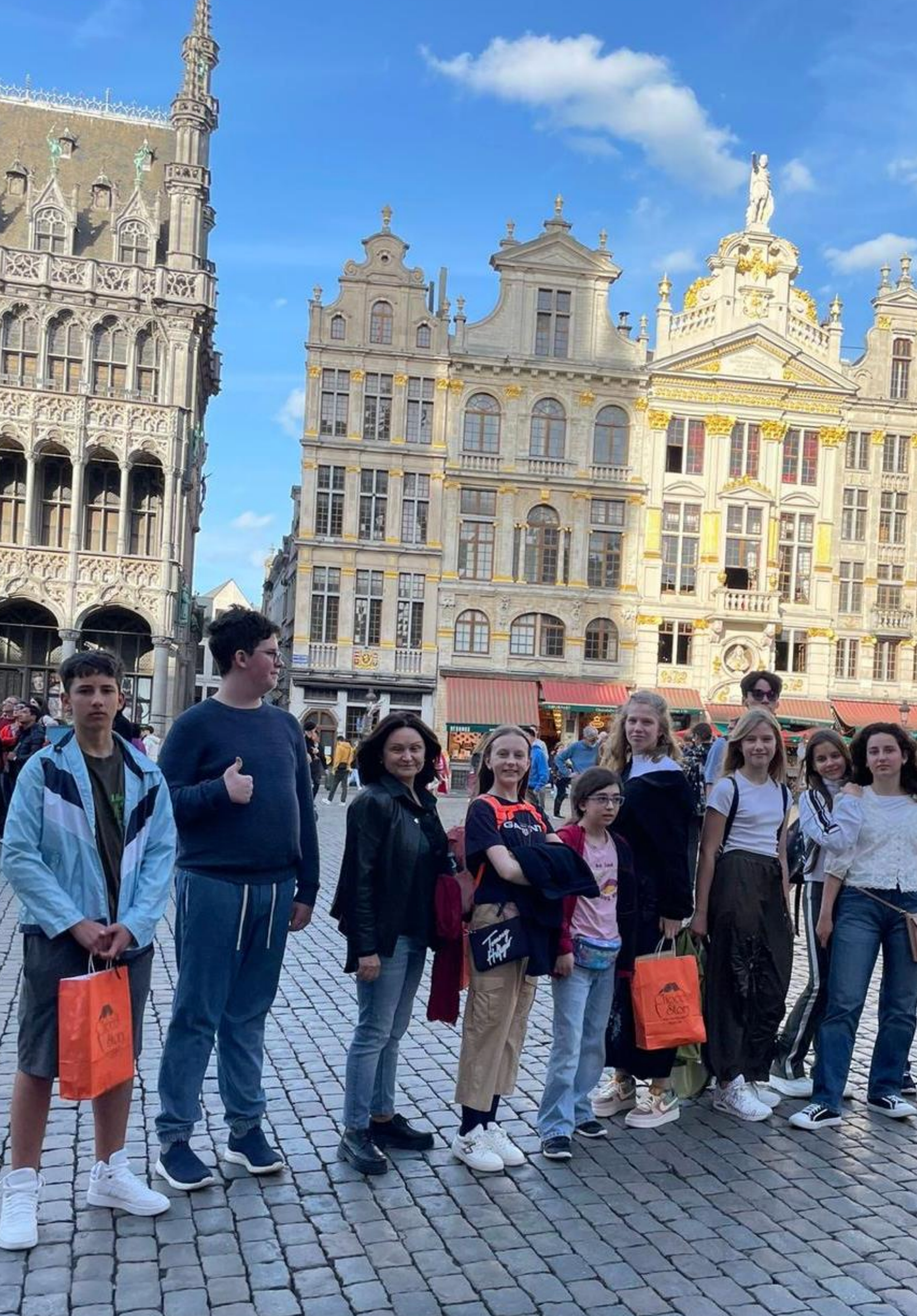 A group of people are standing in front of a building.