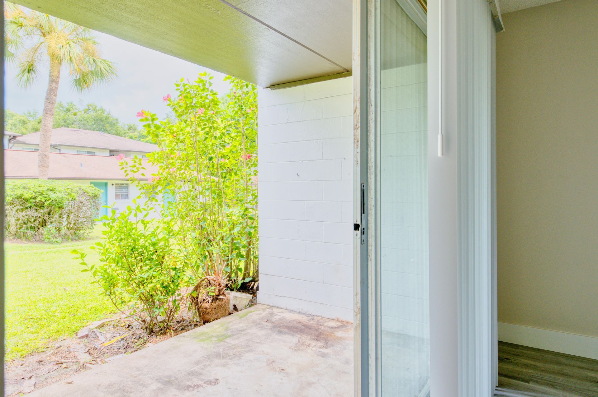 A sliding glass door leading to a patio in an apartment.