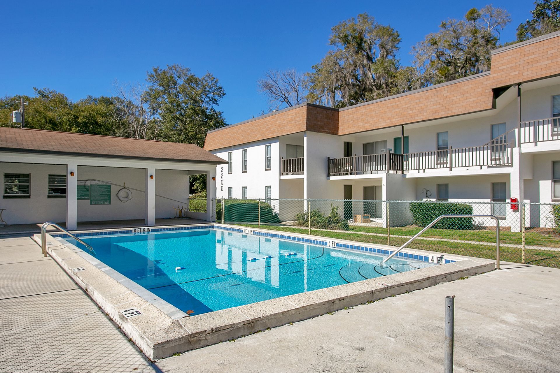 A large swimming pool in front of an apartment building