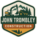 Logo for John Trombley Construction: excavator, cabin, mountains, trees, green, yellow, brown.