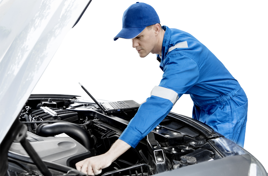 A man in a blue uniform is working on the engine of a car.