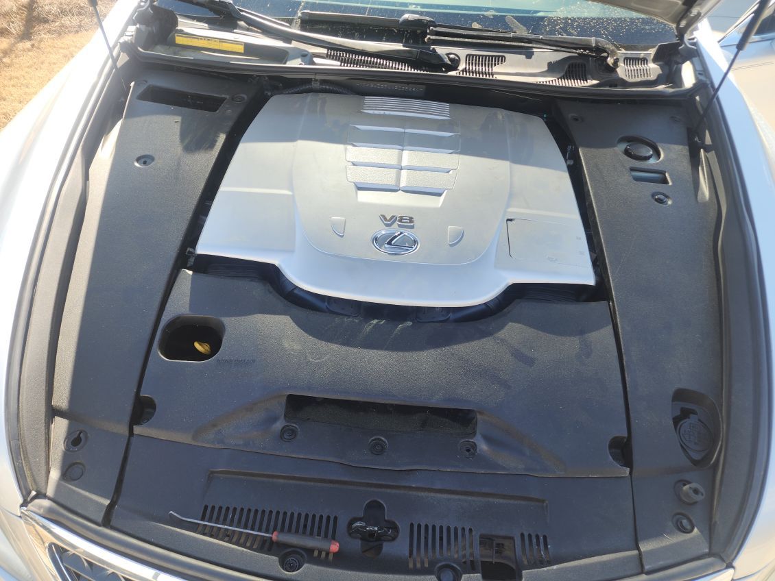 The hood of a car is open and shows the engine