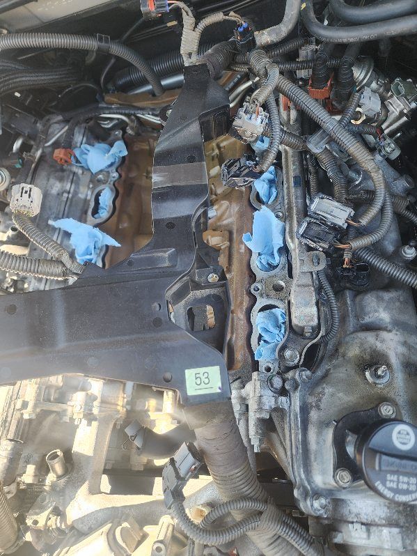 A close up of a car engine with blue cloths on it.