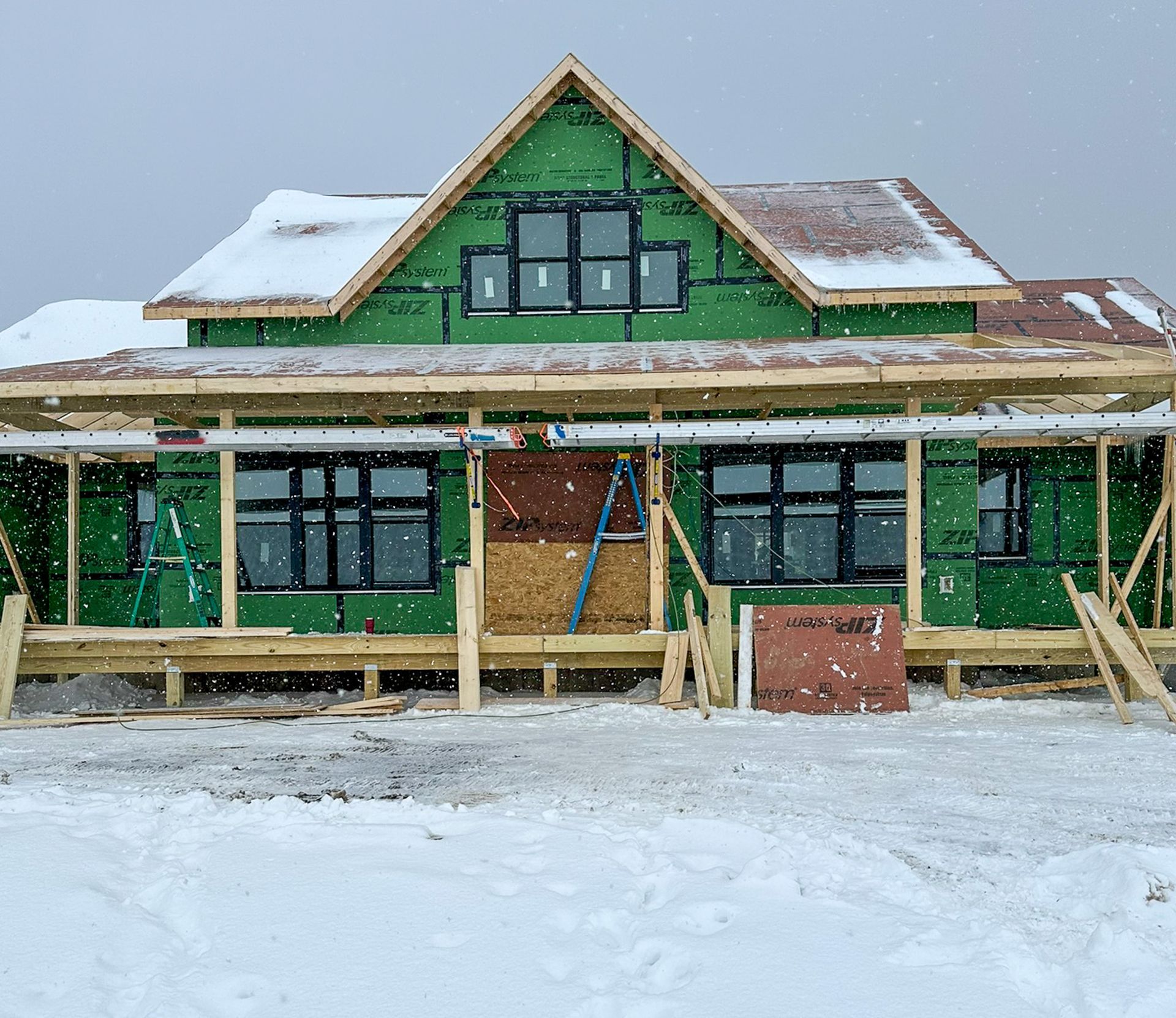 A new custom home that is being built in the snow
