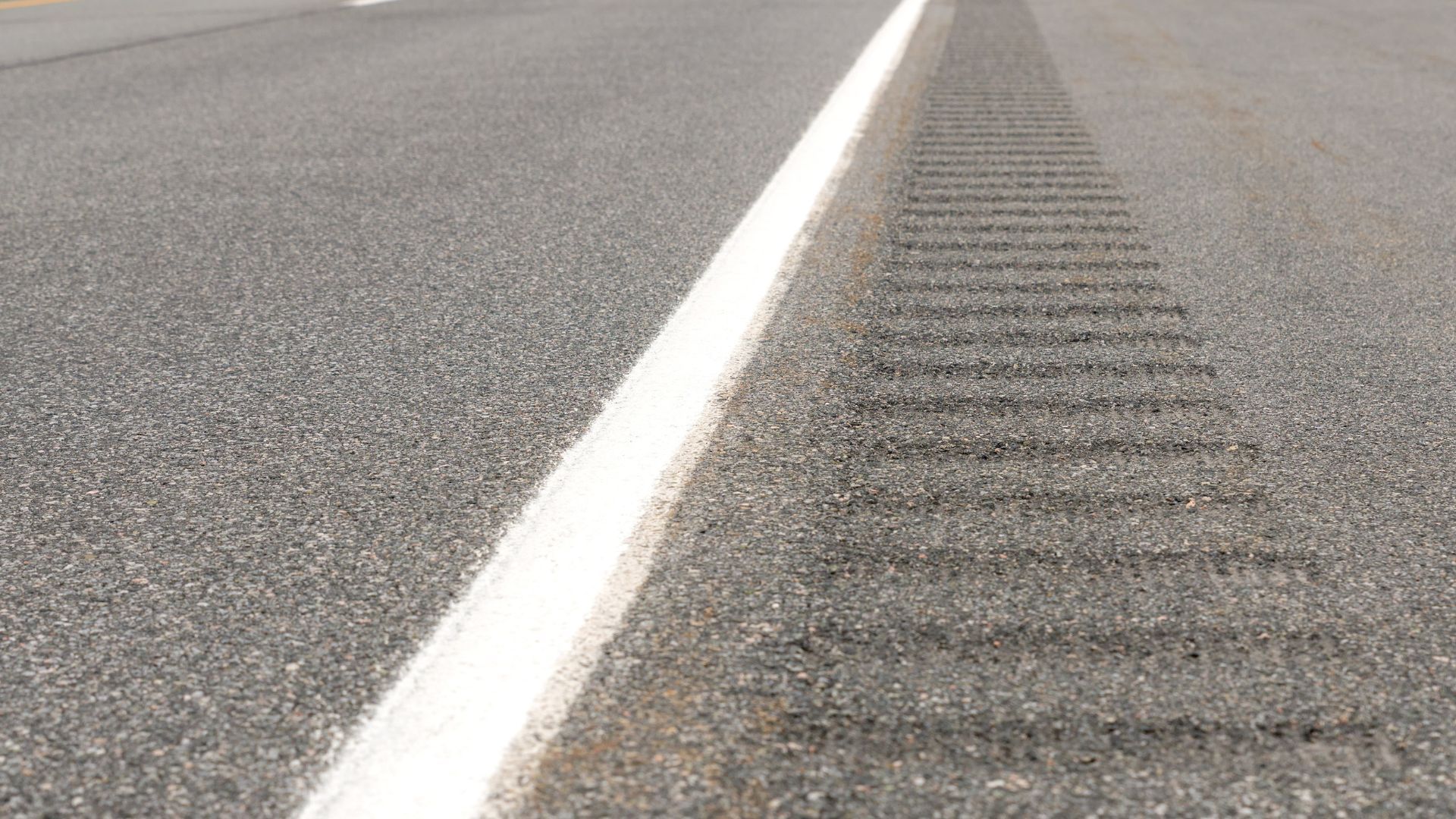 A close up of a white line on the side of a road.