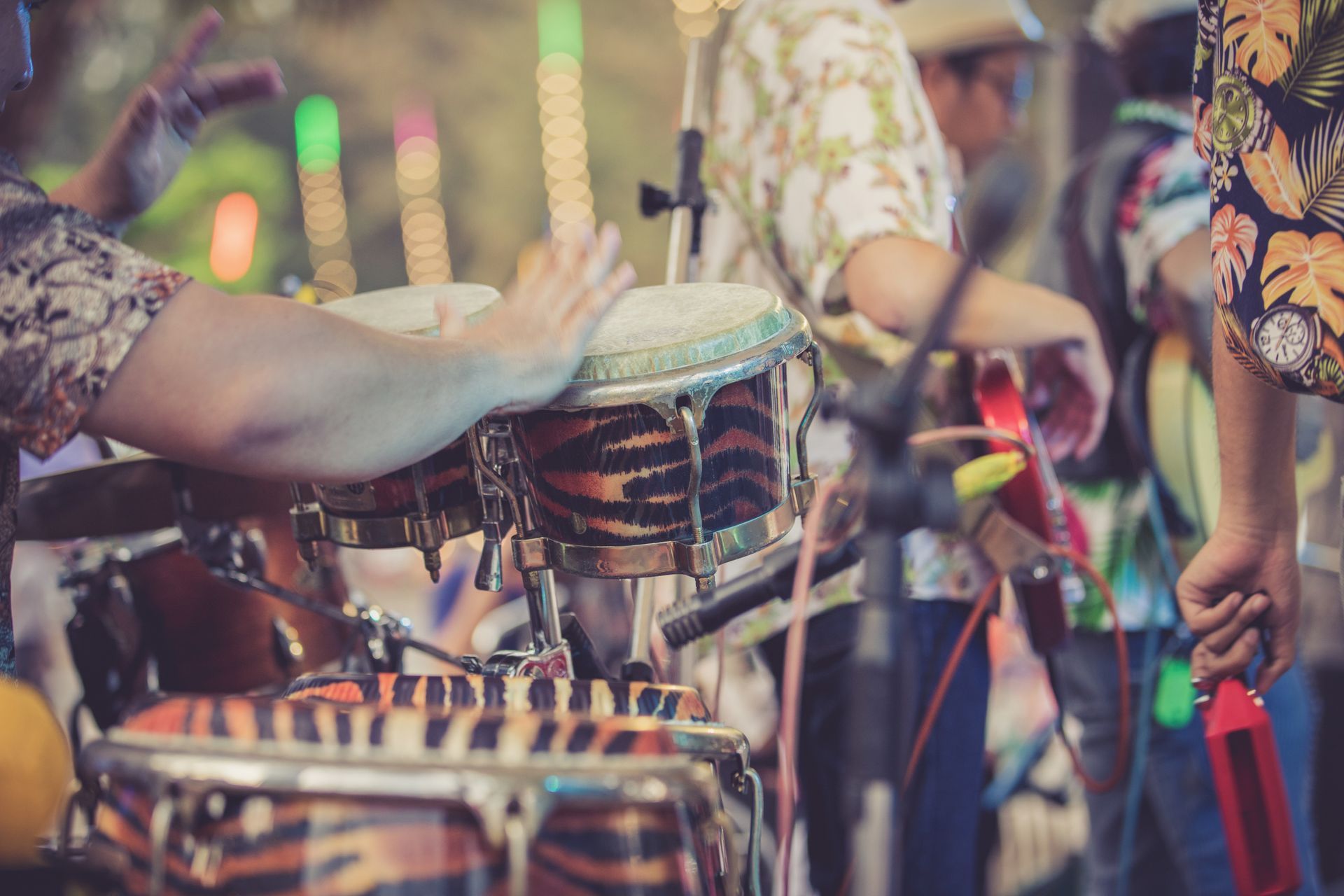 A group of people are playing drums on a stage.