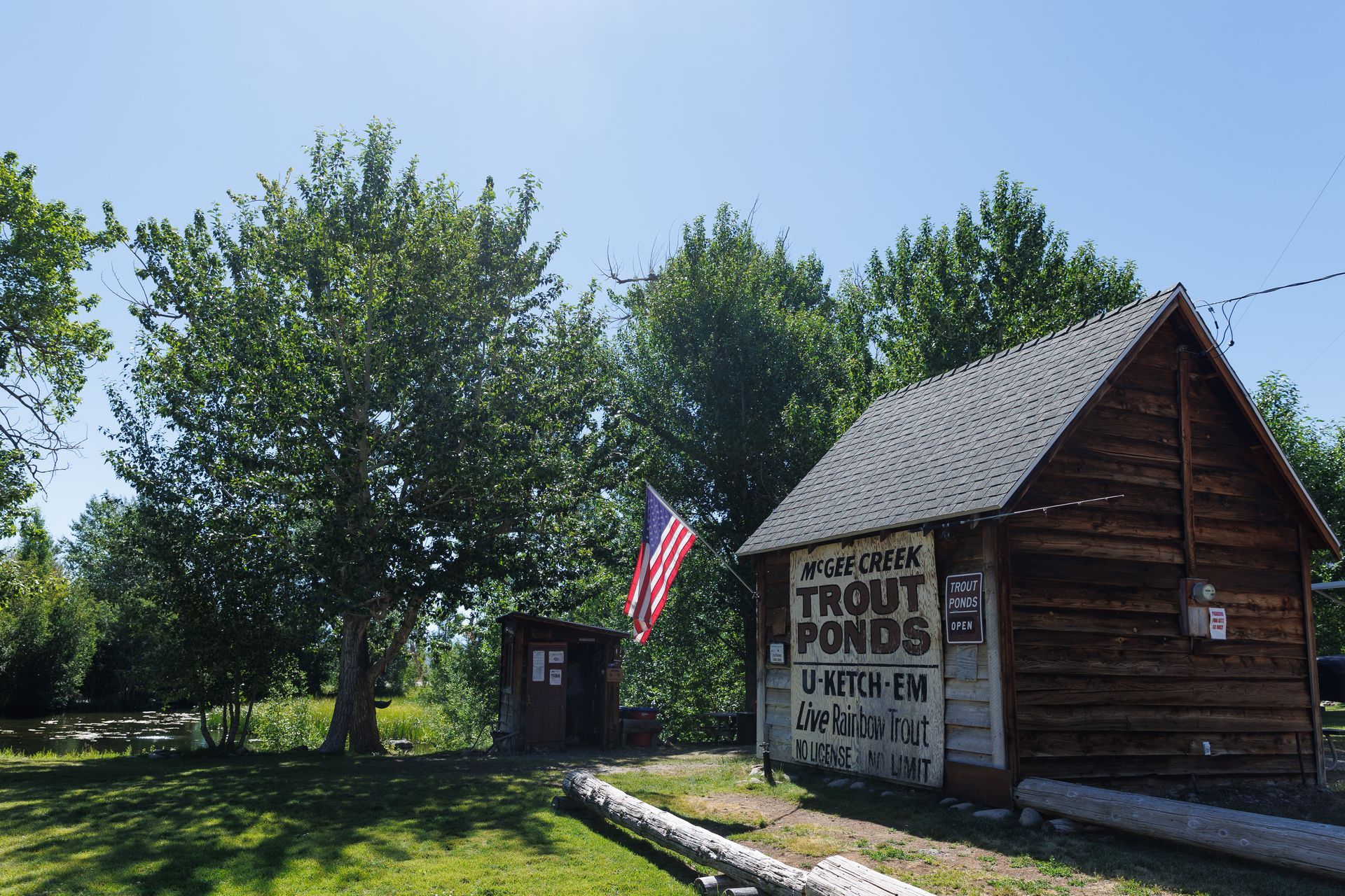 A wooden cabin with a sign that says trout ponds