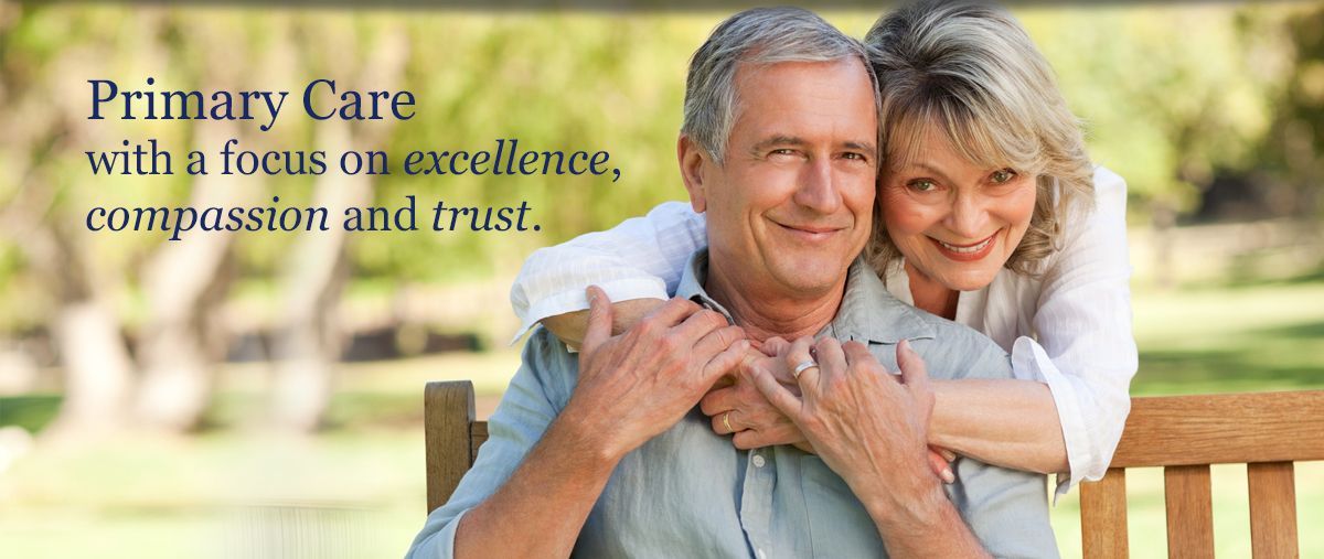 A man and woman are sitting on a bench with a focus on excellence , compassion and trust.