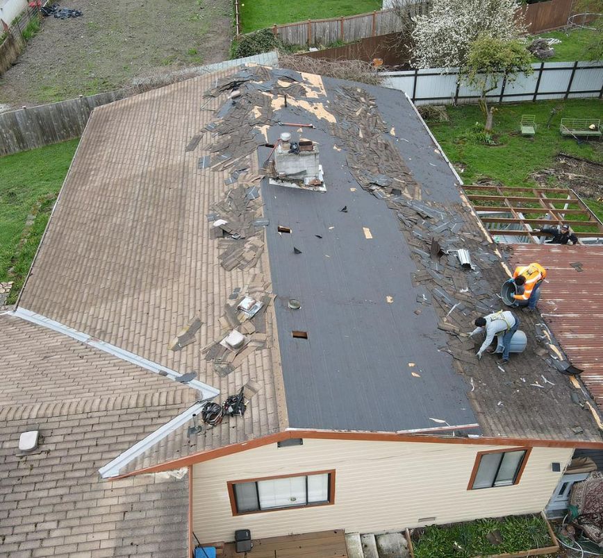 An aerial view of a house with a roof that is being repaired