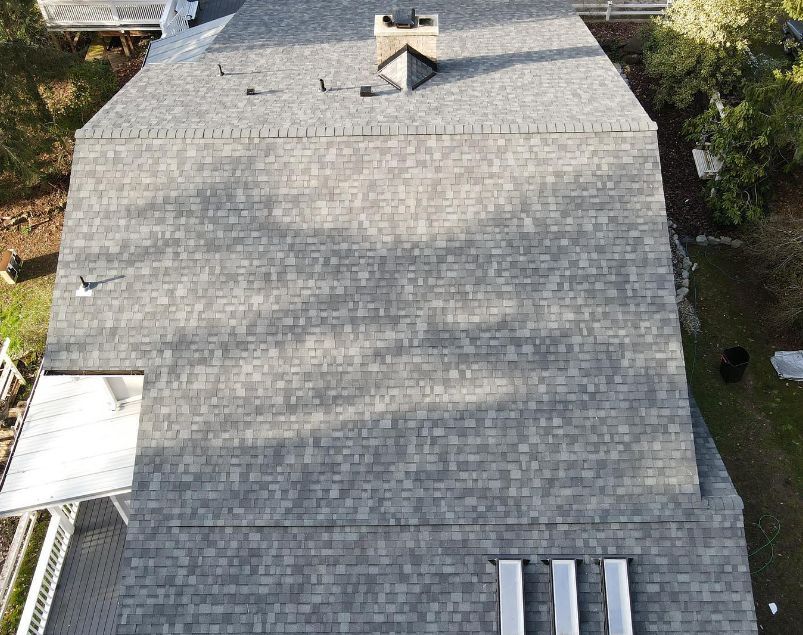 An aerial view of a roof of a house with a chimney.