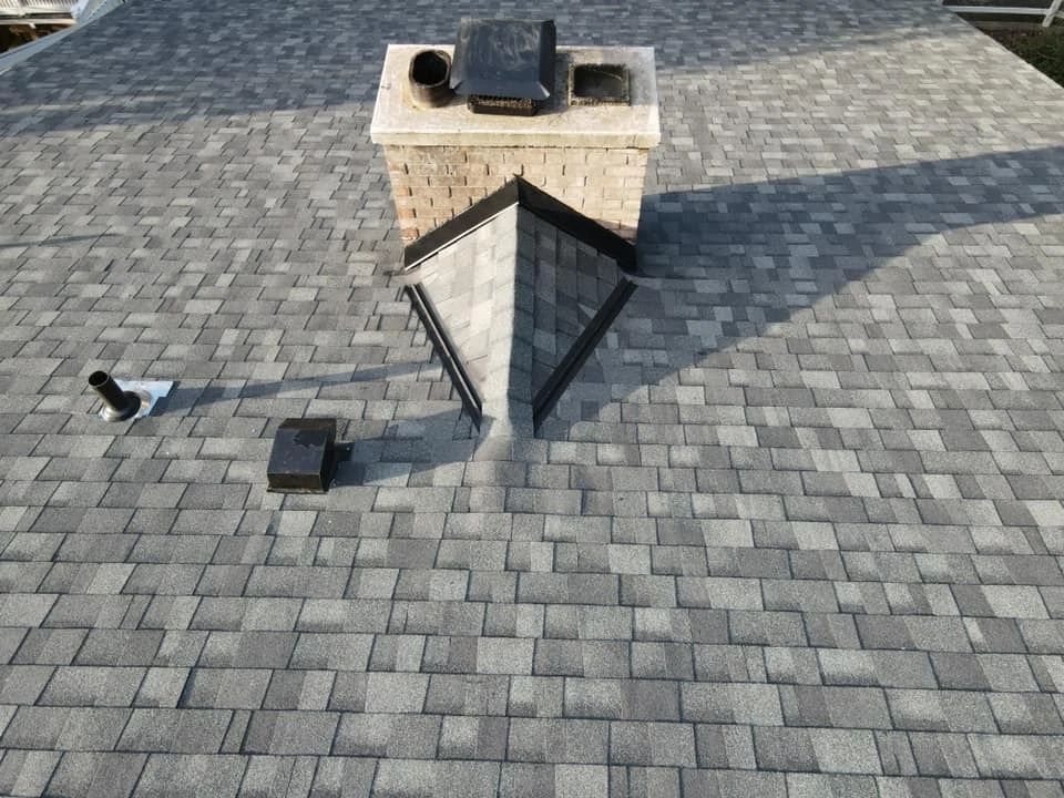 A brick roof with a chimney on top of it