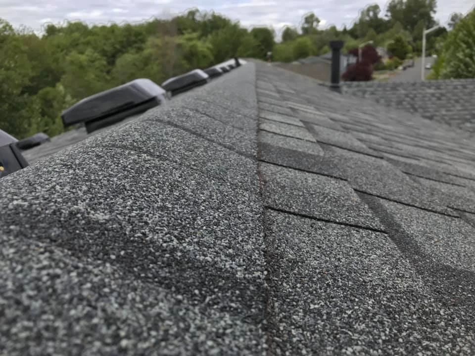 A close up of a roof with a lot of shingles on it.