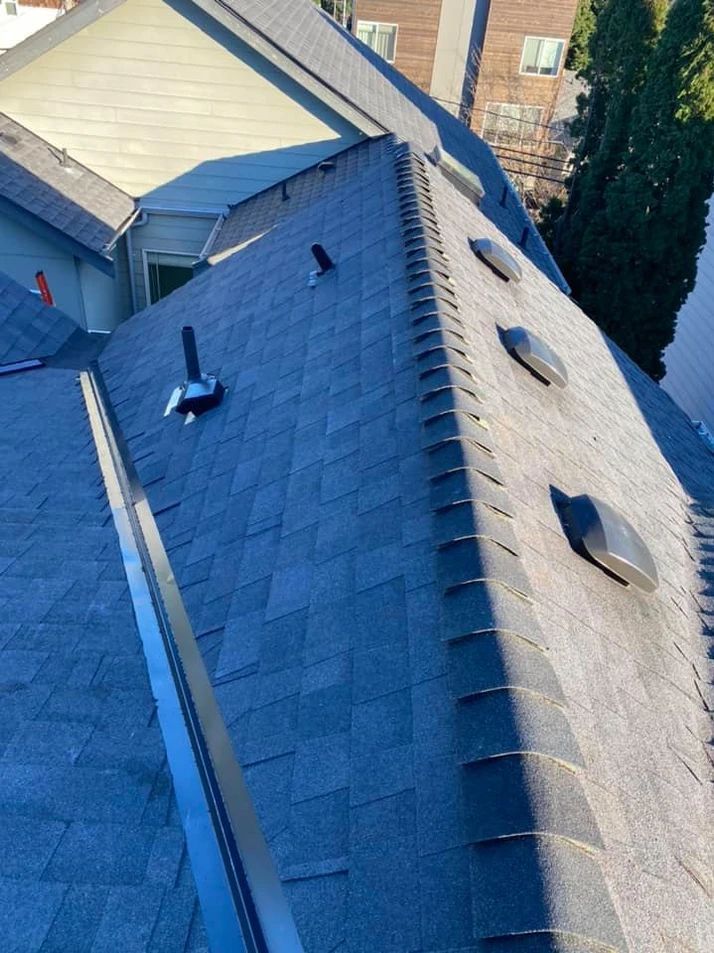 The roof of a house has a lot of shingles on it.