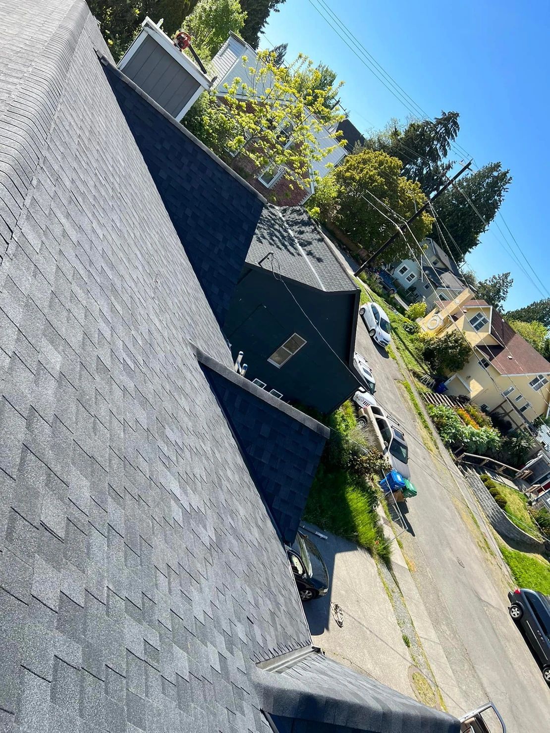 An aerial view of a roof of a house in a residential area.