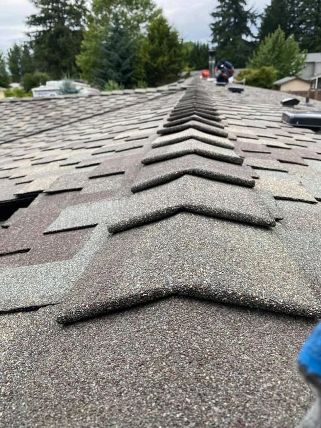 A close up of a roof with a lot of shingles on it.