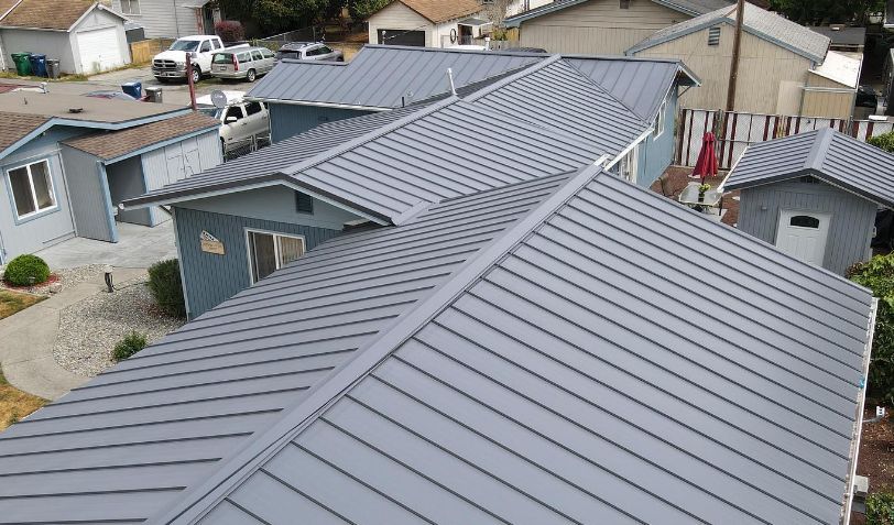 An aerial view of a house with a metal roof.