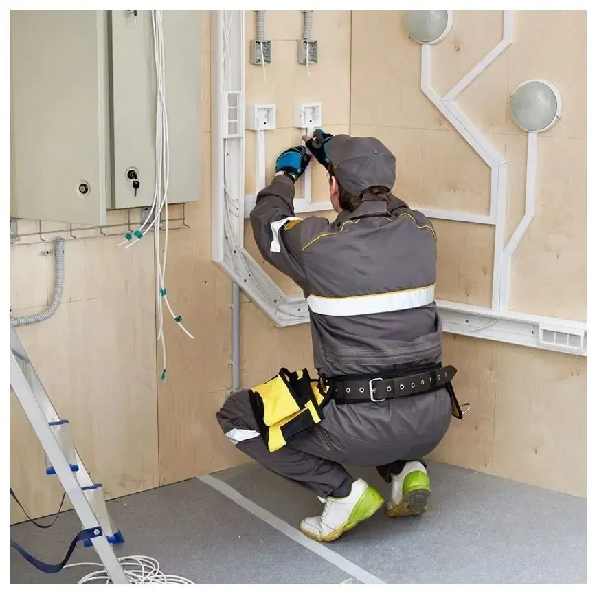 A man is working on a wall with a ladder in the background