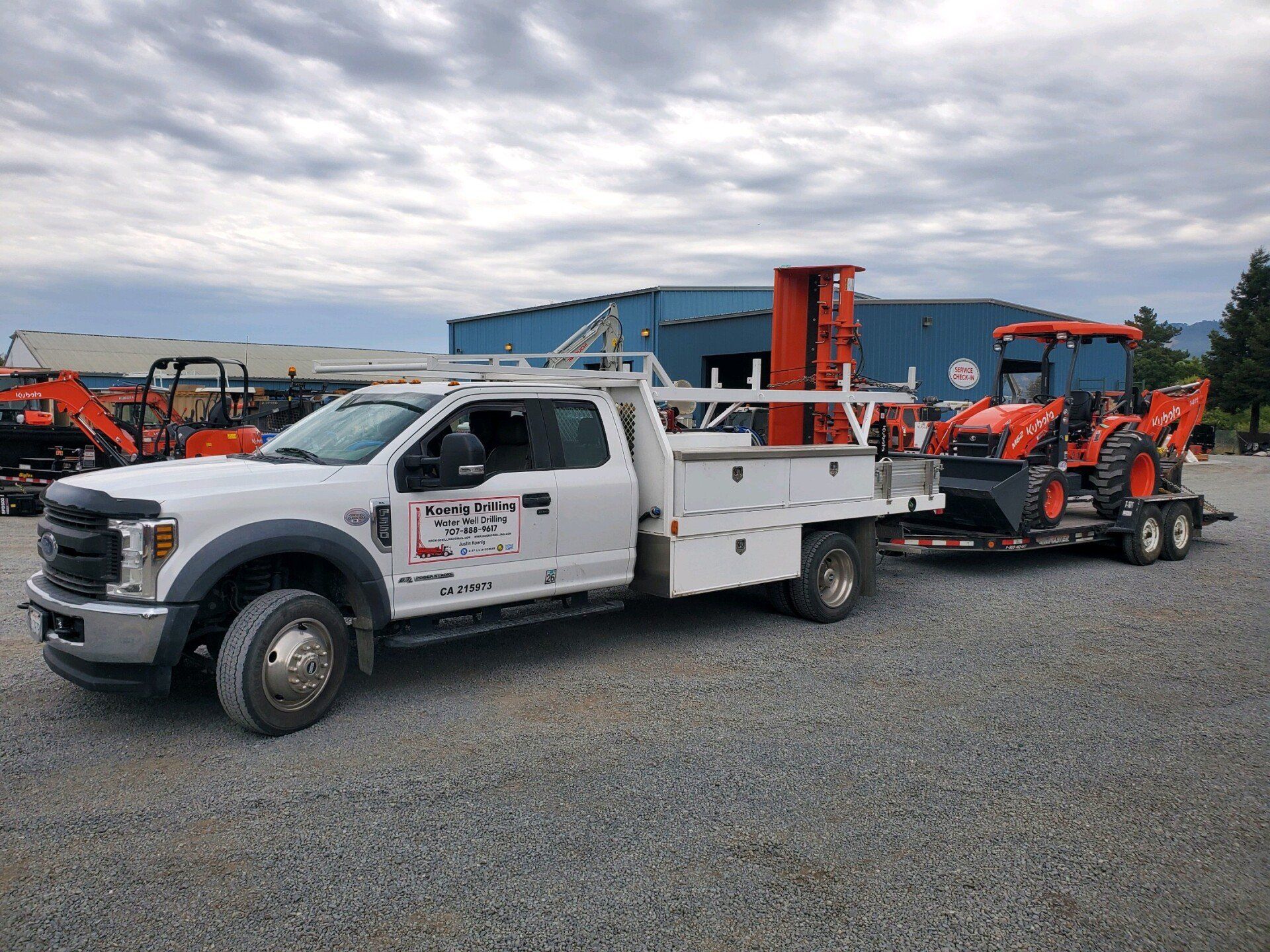 Truck With Backhoe Loader At The Back - Sonoma, CA - Koenig Drilling