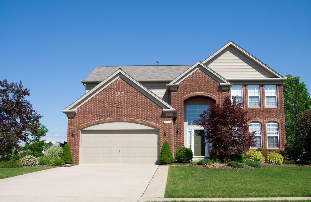 A large brick house with a garage and a driveway