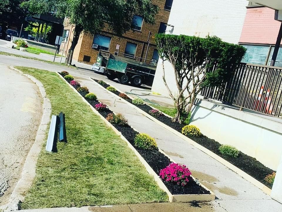 a truck is parked on the side of the road in front of a building .