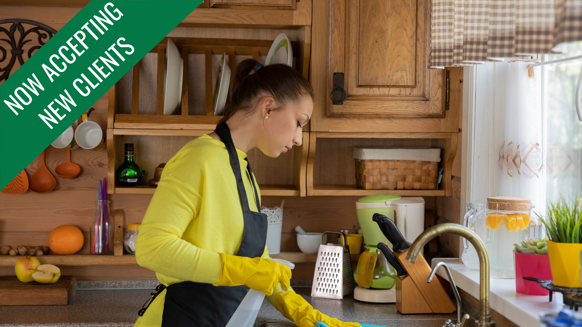 Woman in yellow shirt and gloves cleans kitchen sink.
