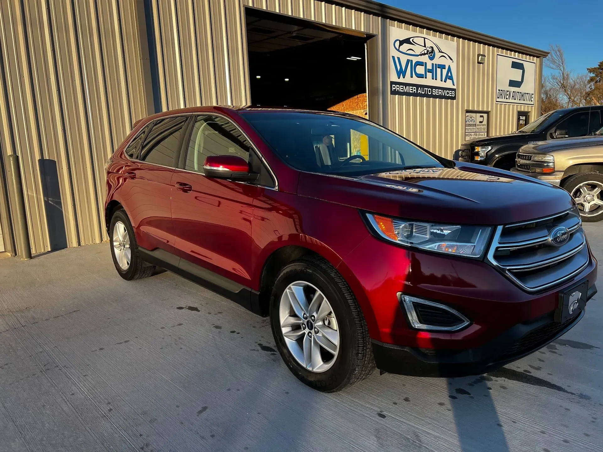 Red Ford Edge SUV parked outside a car dealership in Wichita. | Gearhead Autoworks