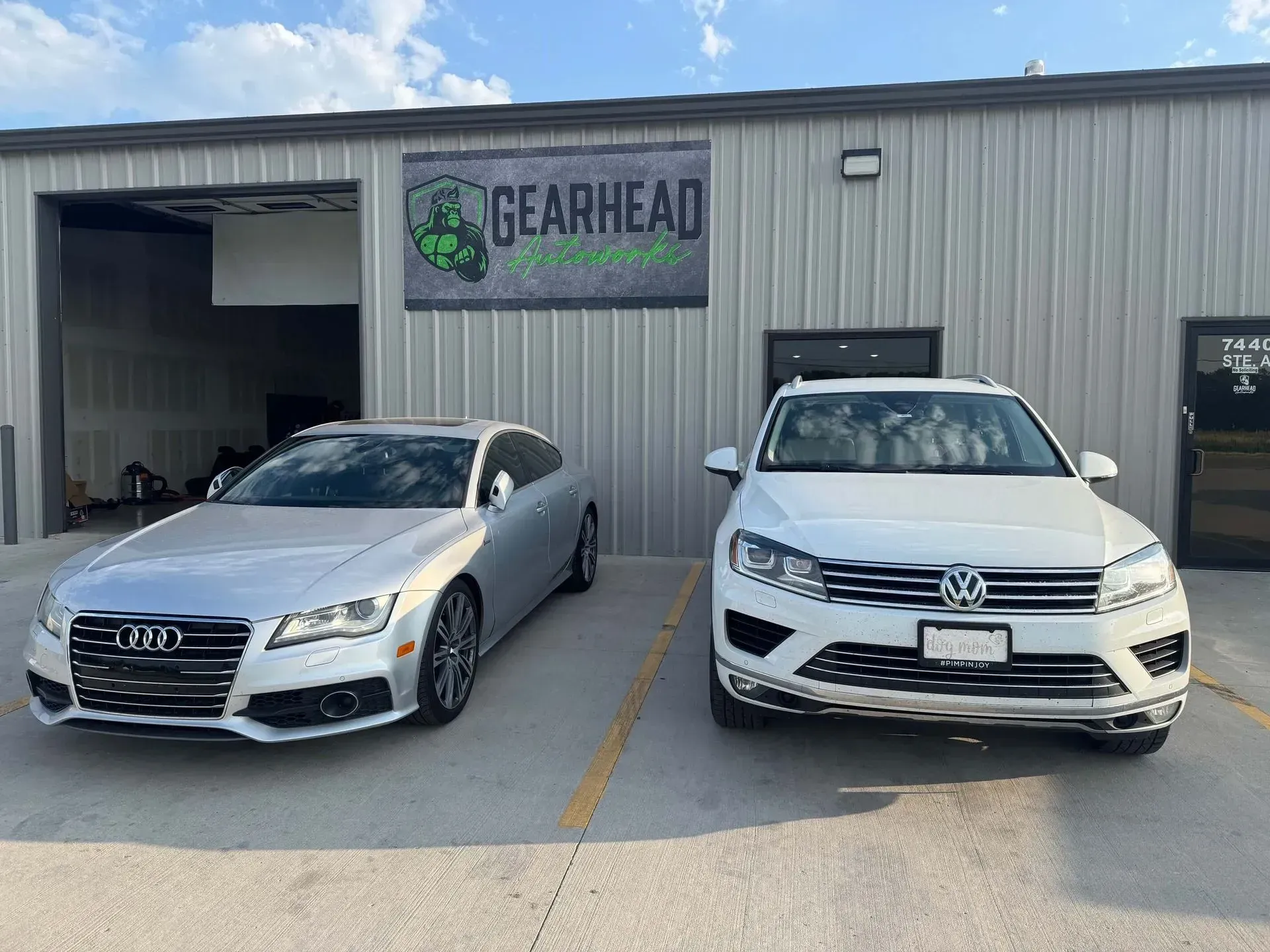 Silver Audi and white Volkswagen parked in front of 