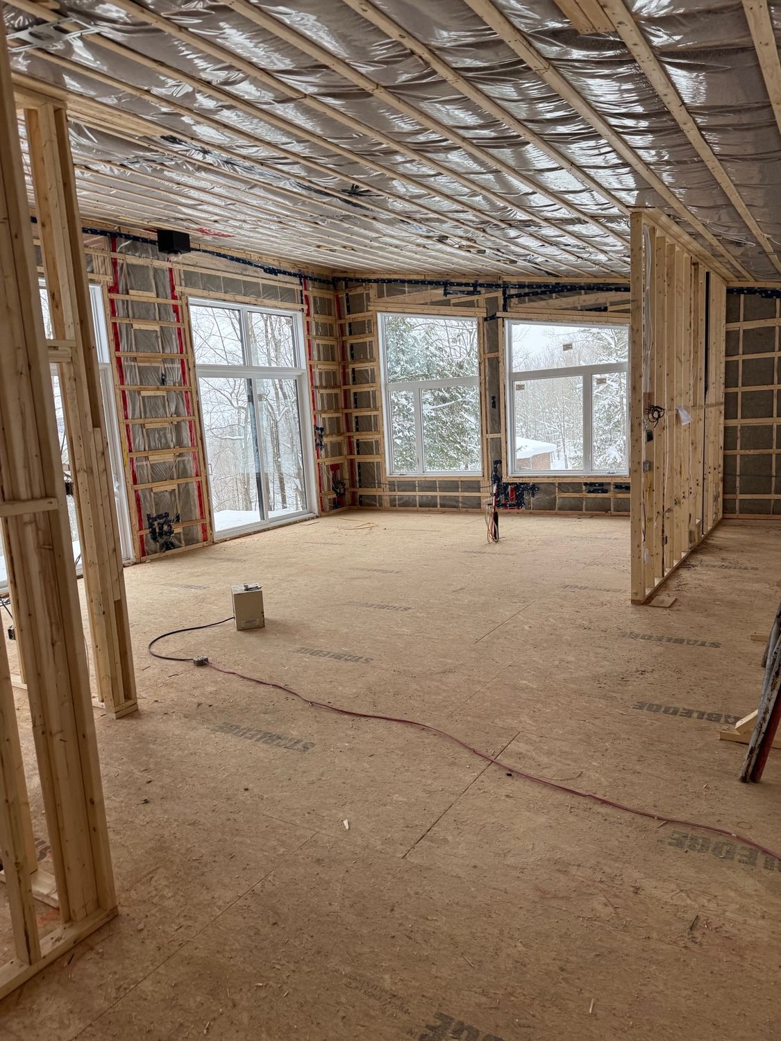 A large room with a lot of windows under construction.