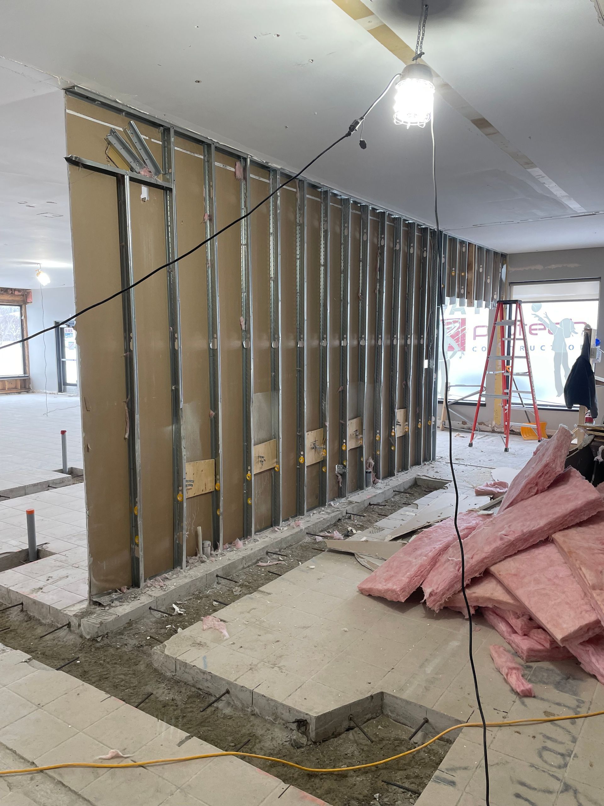 A room that is being remodeled with a ladder in the background