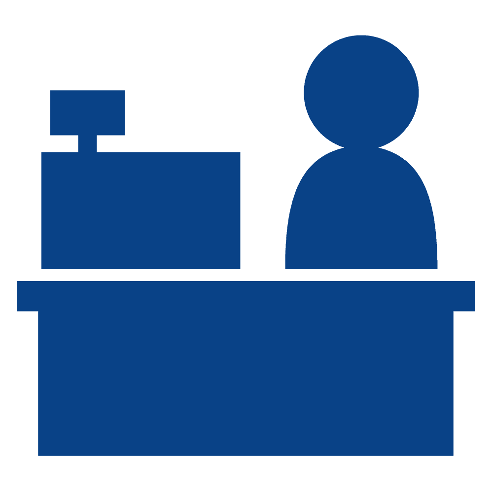 A blue icon of a person sitting at a desk with a computer.