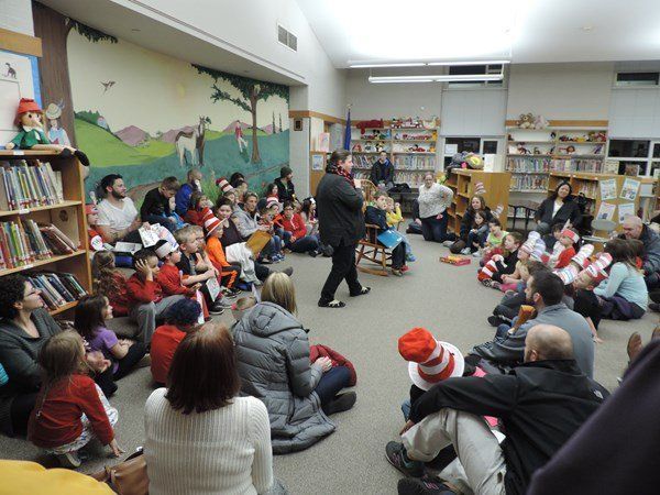 A group of people are sitting in a circle in a library.